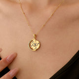 Gold necklace with a pendant on a person's neck