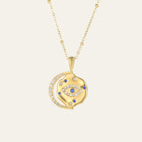 Gold necklace with an eye-shaped pendant on a beige background. This is Mettle & Bloom's signature style.
