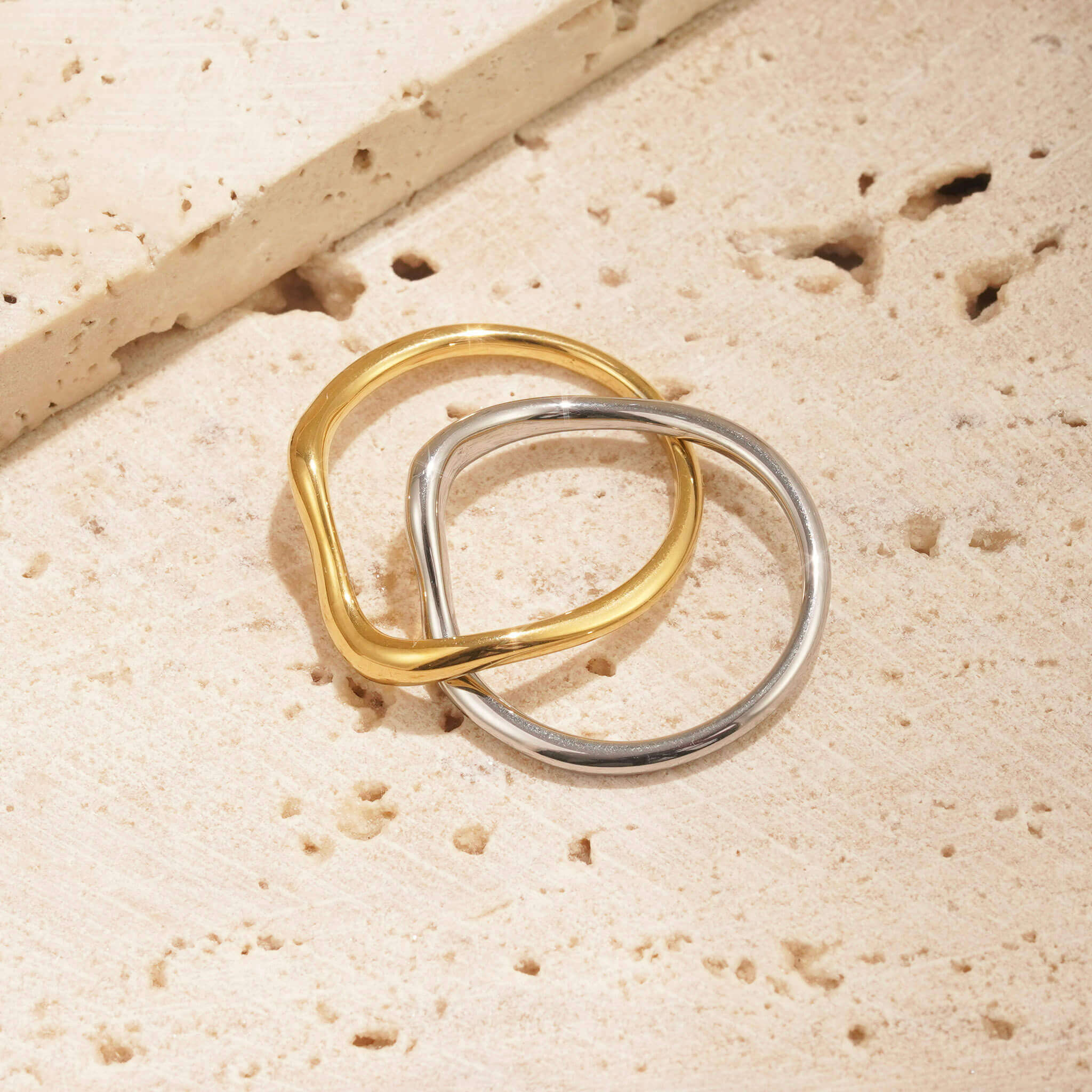 TWO TONE METAL JEWELLERY. this two tone ring has a gold band and a silver band, both of which are attached. they weave together to create a unique design. 