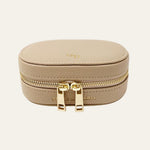Beige jewelry box with gold zipper and Mettle & Bloom branding on a white background