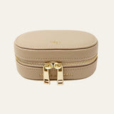 Beige jewelry box with gold zipper and Mettle & Bloom branding on a white background