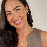 The 'Muse Hoops' from Mettle & Bloom - a pair of double band gold hoop earrings. Crafted with precision, the hoops feature a steel-plated finish for durability and a lustrous appeal. A seamless blend of timeless elegance and contemporary style, these earrings offer a versatile accessory to elevate your look. Available now at Mettle & Bloom, the Muse Hoops embody modern sophistication with their exquisite design.