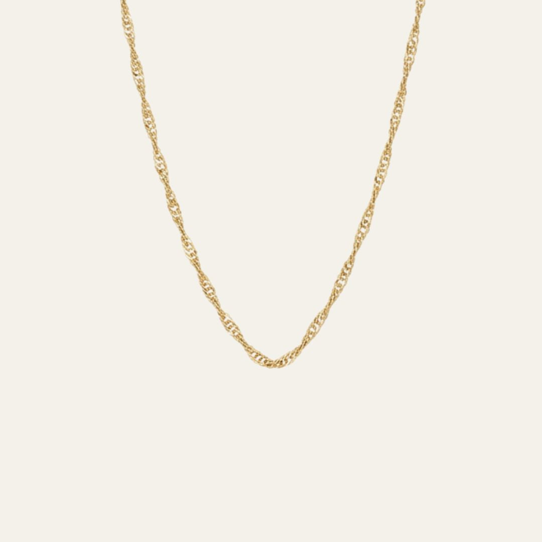 A delicate and thin gold singapore chain necklace with a twisted, rope-like link design, displayed against a solid off-white background.