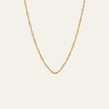 A delicate and thin gold singapore chain necklace with a twisted, rope-like link design, displayed against a solid off-white background.