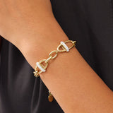 Gold bracelet with diamond accents on a wrist against a black background. Tthis bracelet is an everyday statement, adding a modern glow to both simple and elevated looks.