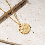 to the Moon & Back Necklace on a stone background