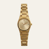 A gold-tone metal wristwatch with a matching link bracelet, featuring a champagne-gold dial with a date window and the 'Mette & Bjoern' brand name printed on the face, set against a solid off-white background.